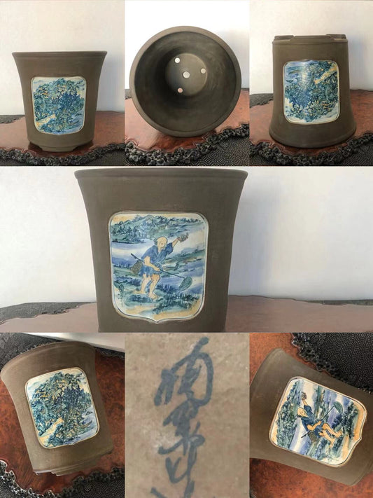 Dark brown ceramic pot with blue and white painted landscape panel on front.