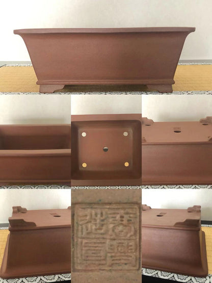 A matte brown rectangular pot with four footed legs and a central stamped seal.