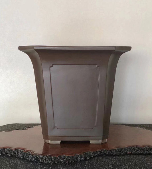 Dark brown glazed ceramic pot with flared rim and recessed rectangular panel.