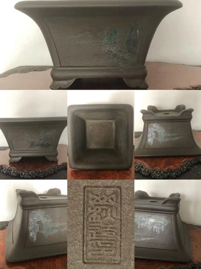 Dark grey glazed square pot with painted landscape and raised seal mark.