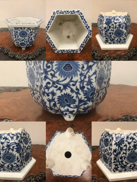 A hexagonal blue and white ceramic pot with intricate floral patterns and a central drainage hole.