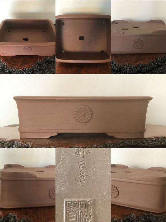 Rectangular terracotta bonsai pot with sunburst relief and carved signature on base.