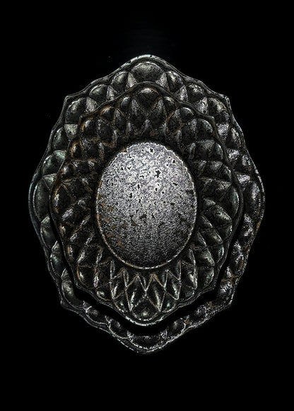 Deep black plate with a quilted diamond-cut border and a speckled metallic oval at its centre.
